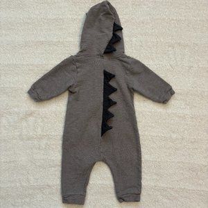 Lala gray hooded romper with dark gray dinosaur horns on back and hood